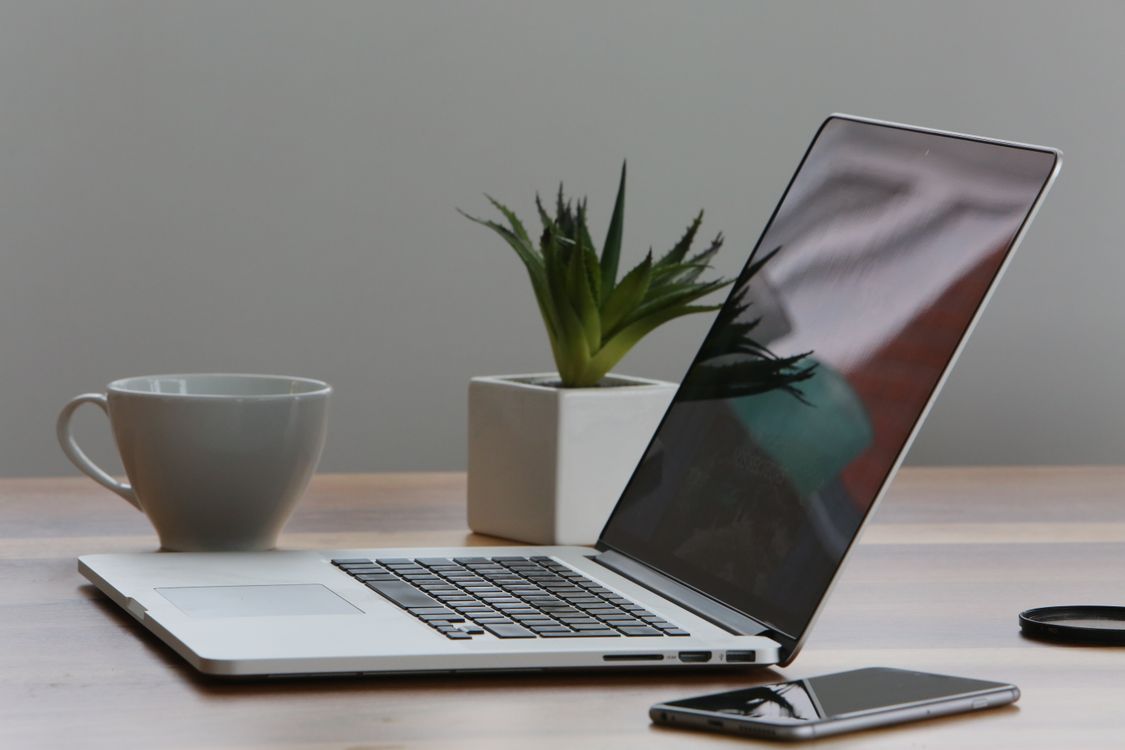 Comparing screenwriting software on laptop