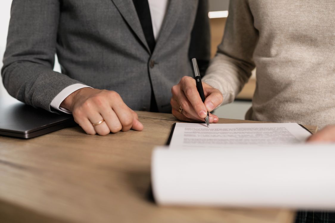 Person signing a legal contract document